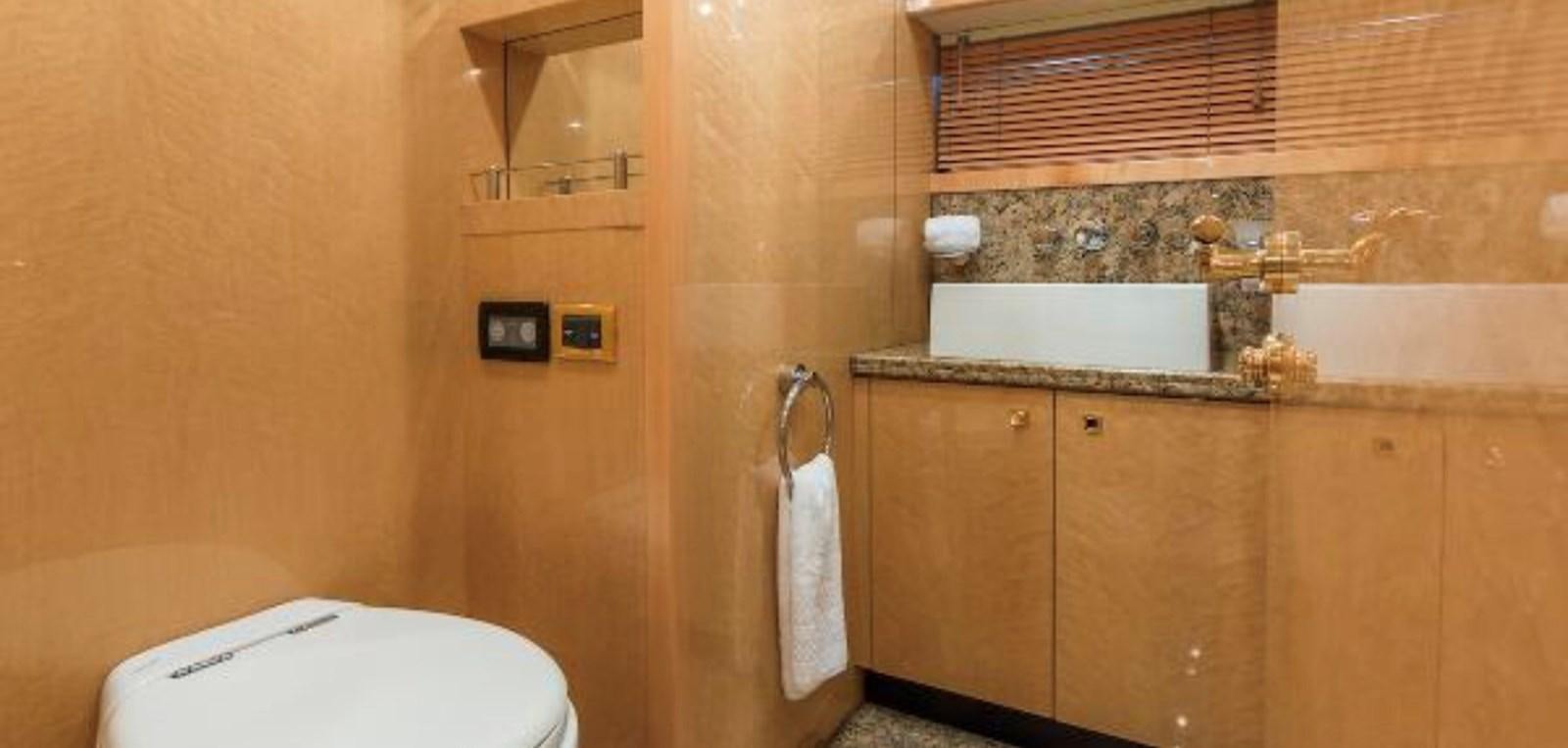 a bathroom with a toilet and a sink aboard UNICO Yacht for Sale