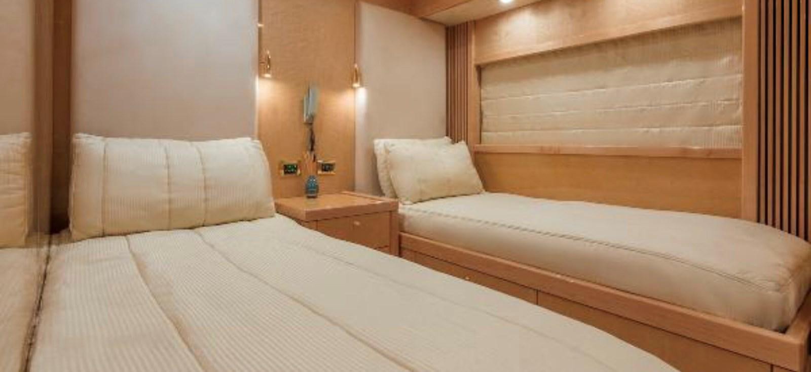 a room with a bed and a wooden headboard aboard UNICO Yacht for Sale