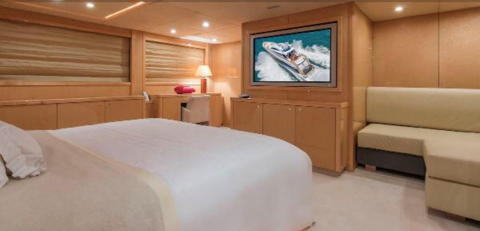 a room with a bed and a television aboard UNICO Yacht for Sale