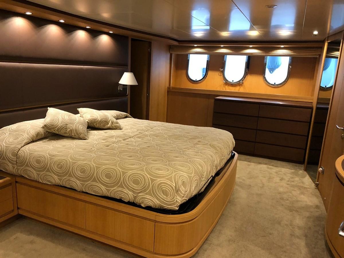a bed with a wooden headboard aboard FIFTH AVENUE Yacht for Sale
