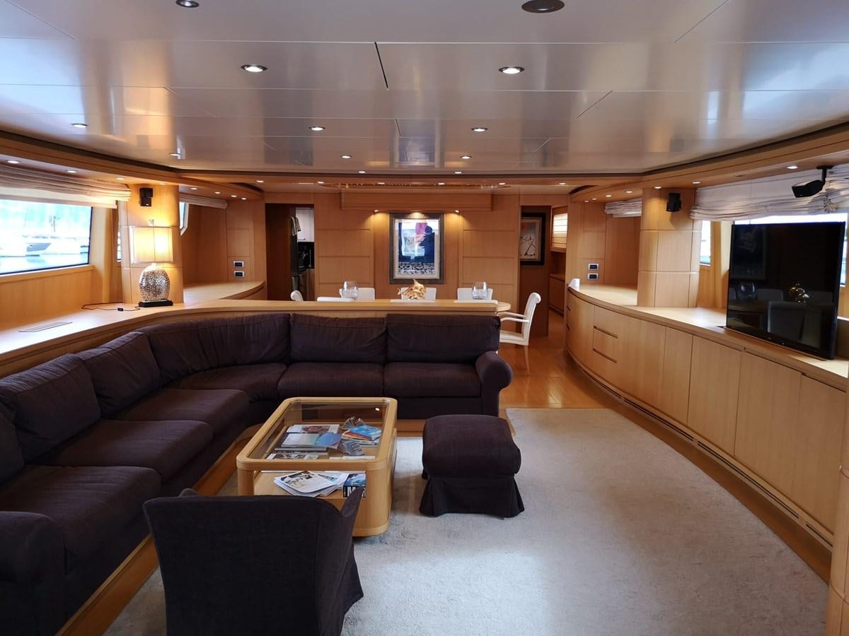 a living room with leather couches aboard FIFTH AVENUE Yacht for Sale