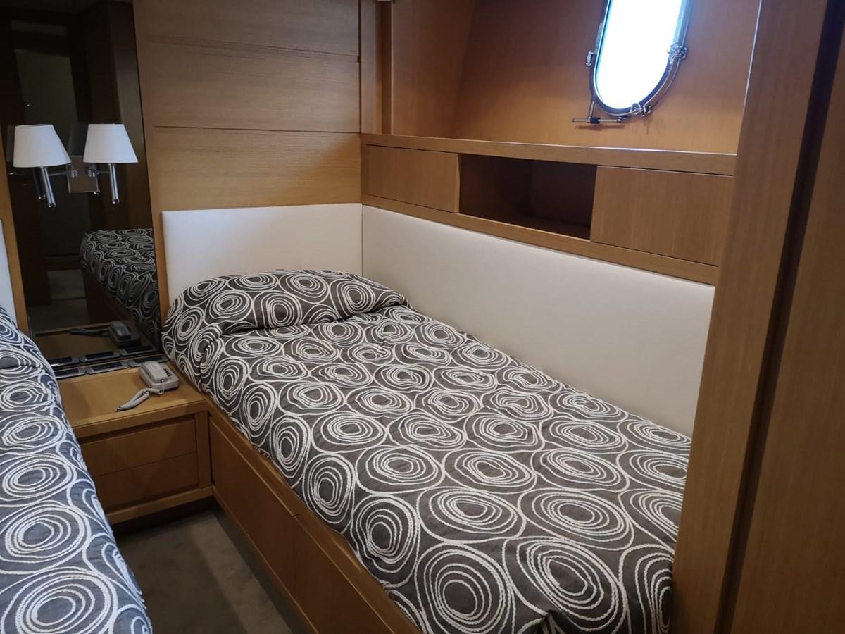 a bed with a white comforter aboard FIFTH AVENUE Yacht for Sale