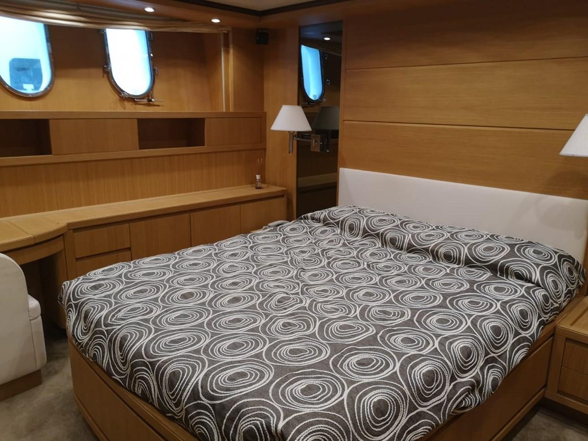a room with a bed and a desk aboard FIFTH AVENUE Yacht for Sale