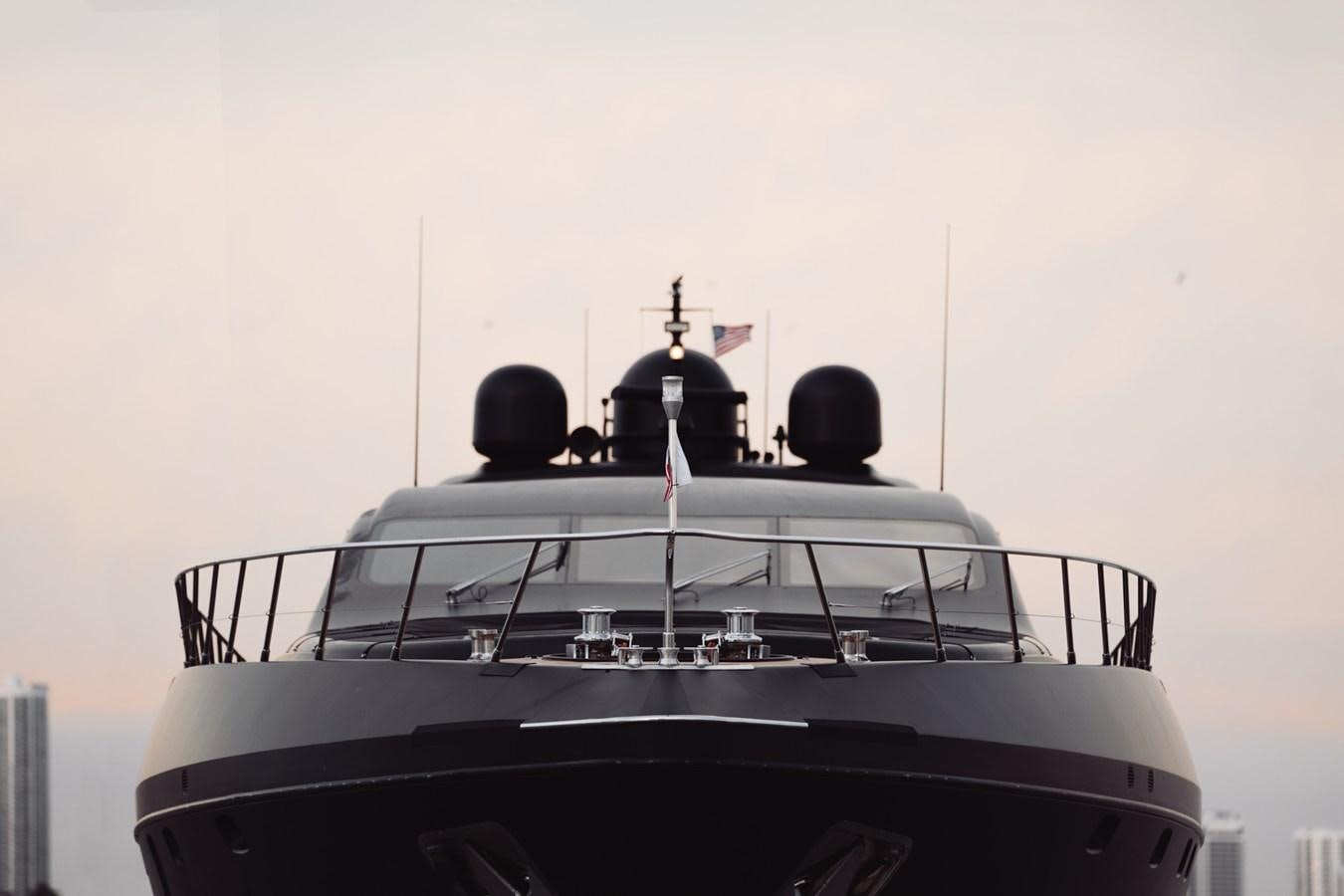 a white boat with a black top aboard MANGUSTA 108 Yacht for Sale