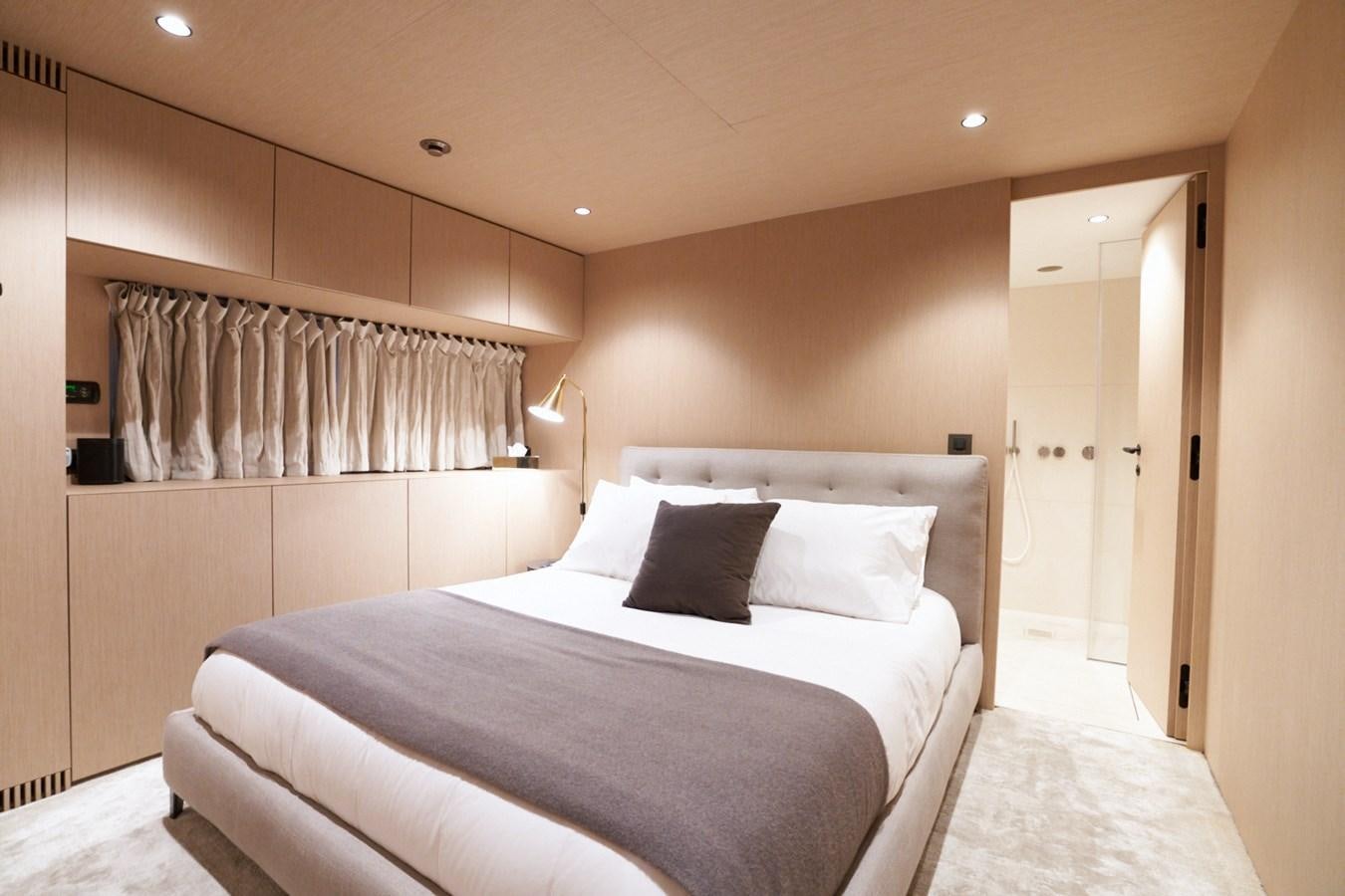 a bed in a room aboard MANGUSTA 108 Yacht for Sale