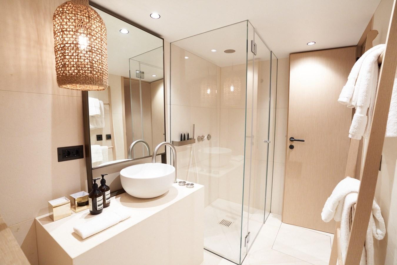 a bathroom with a glass shower aboard MANGUSTA 108 Yacht for Sale
