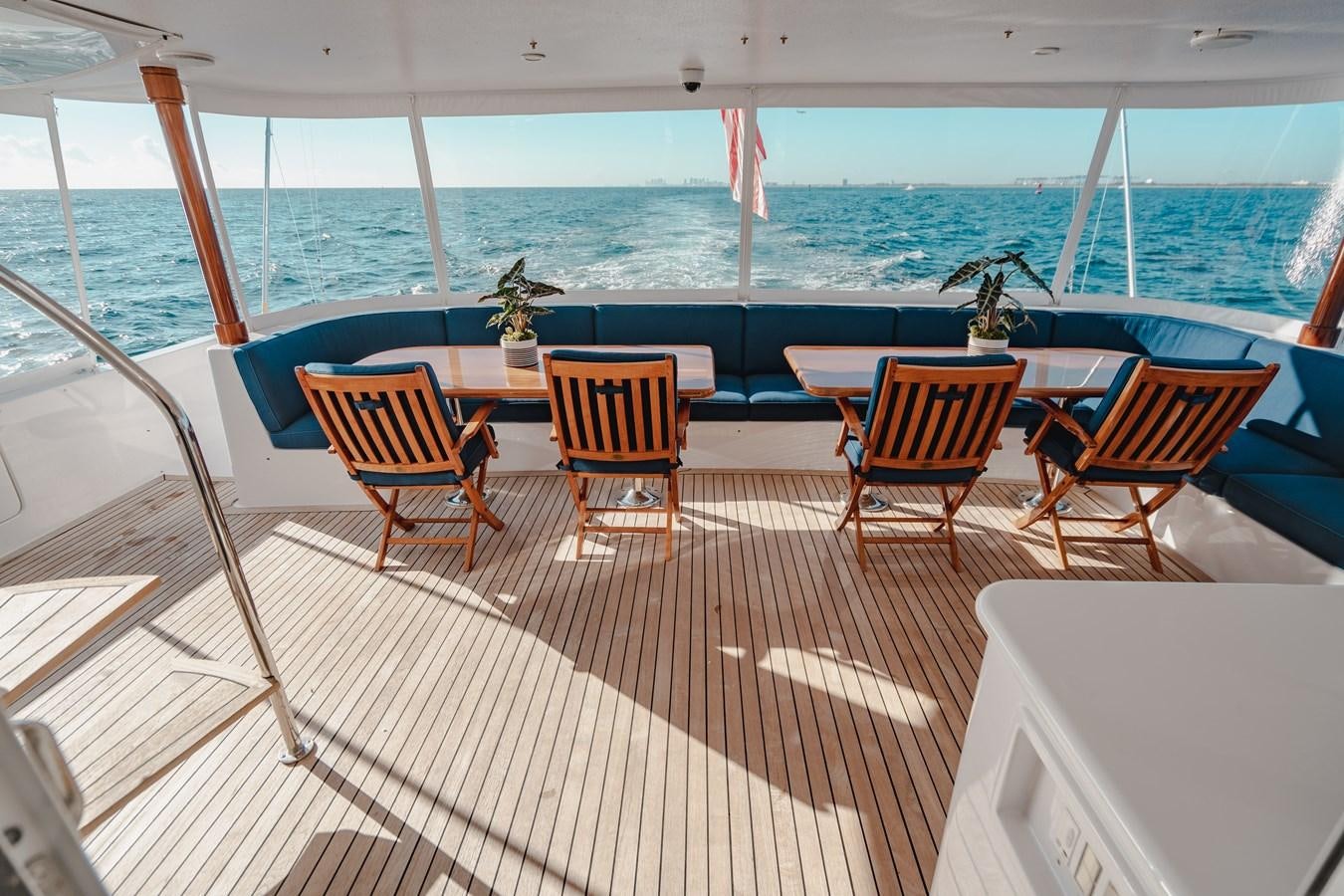 a deck with chairs and a table on it aboard FREE SPIRIT Yacht for Sale