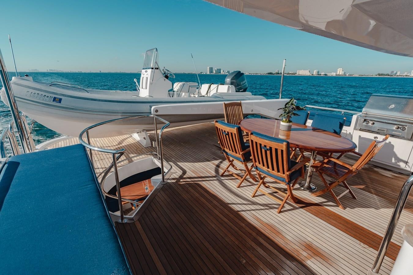 a deck with chairs and tables on it aboard FREE SPIRIT Yacht for Sale