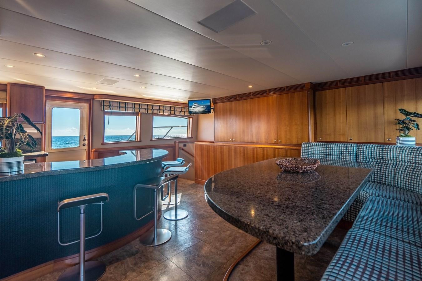 a room with a table and chairs aboard FREE SPIRIT Yacht for Sale