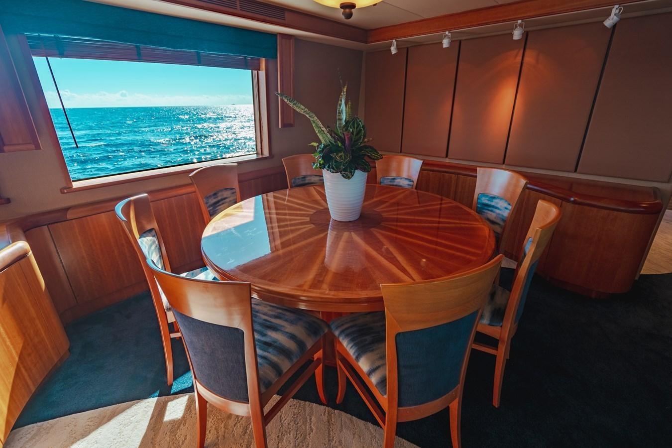 a table with chairs around it aboard FREE SPIRIT Yacht for Sale