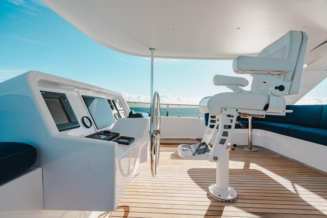 a white chair on a deck aboard FREE SPIRIT Yacht for Sale