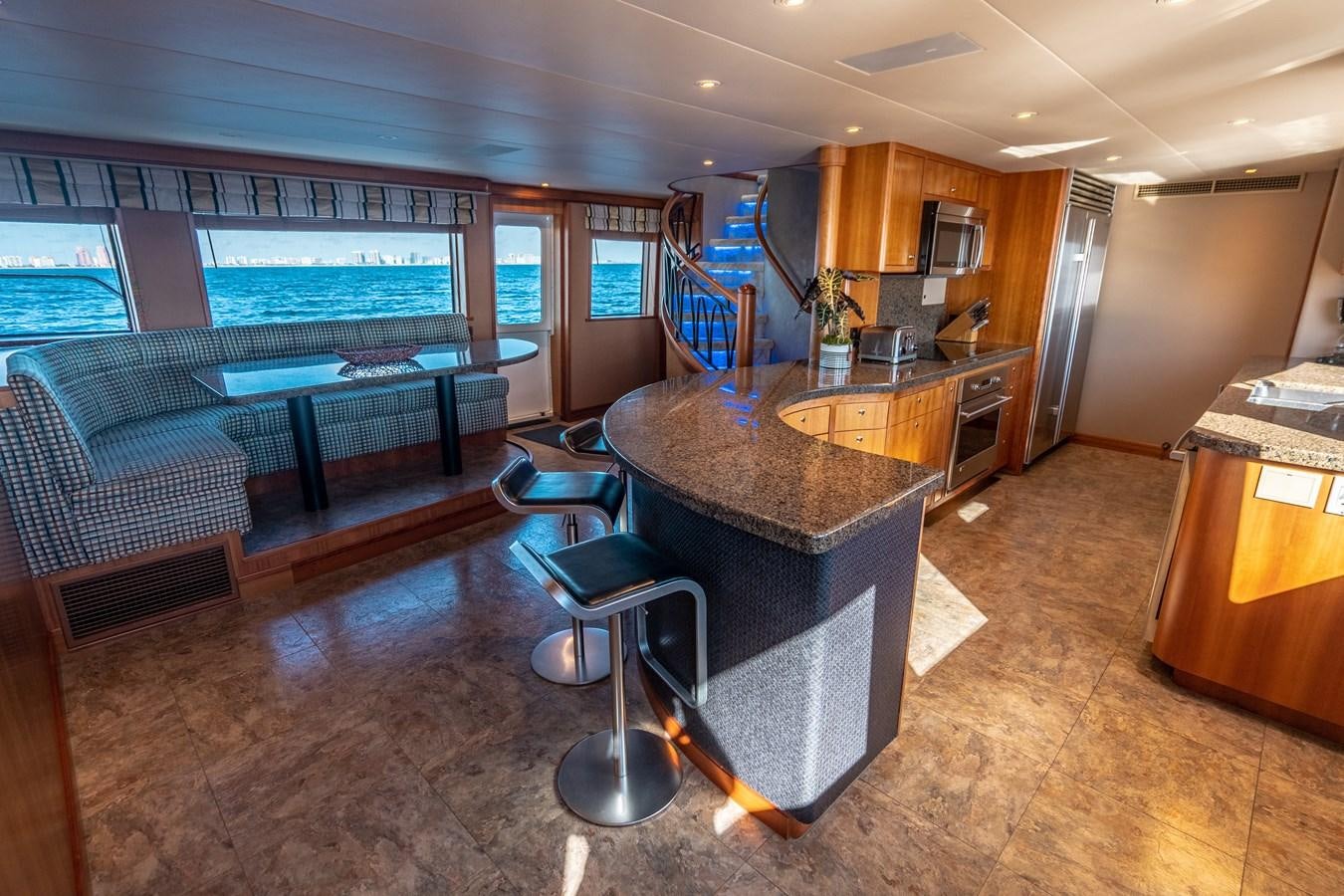 a large living room with a bar and a pool table aboard FREE SPIRIT Yacht for Sale