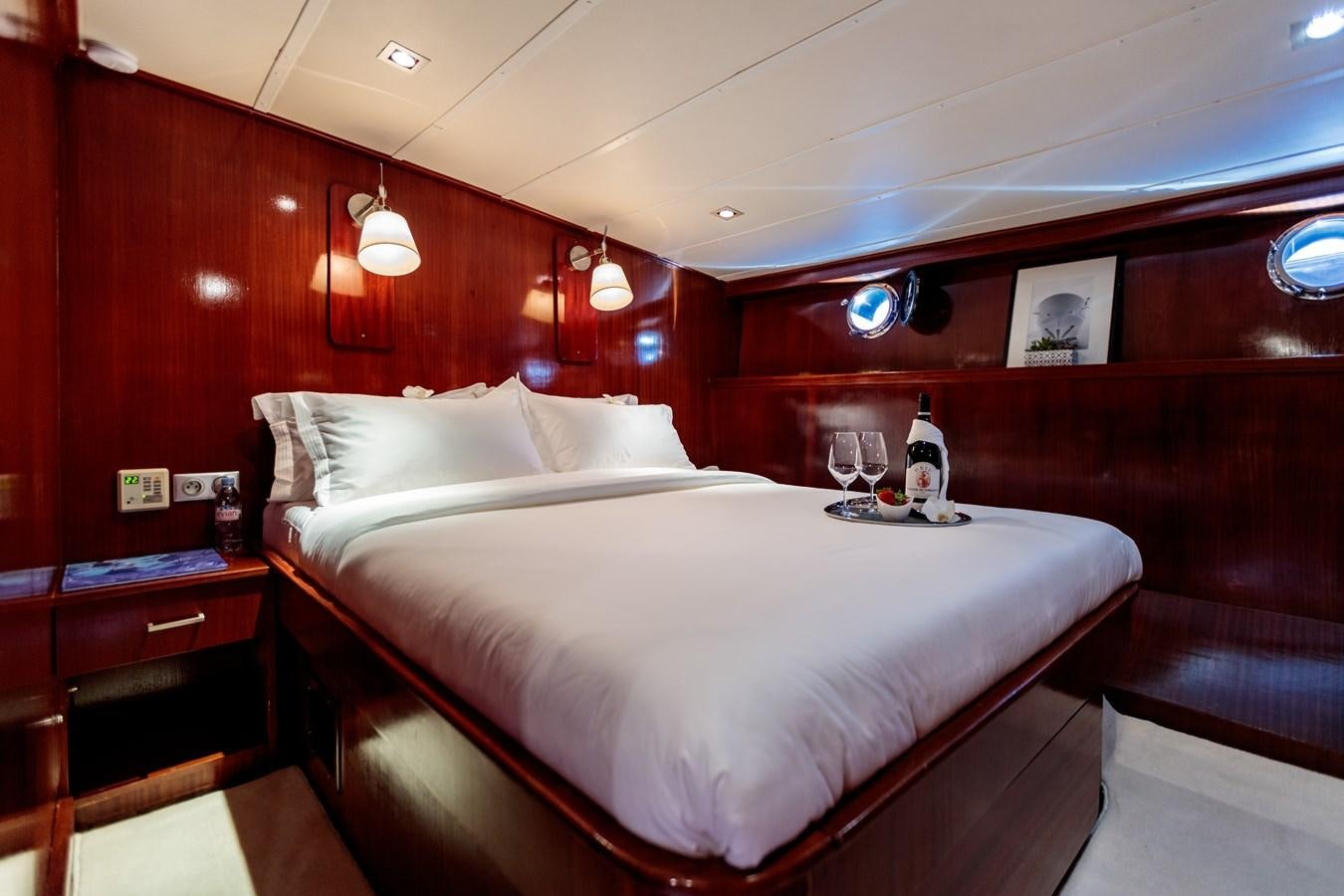 a bed with white sheets and pillows aboard VITA DOLCE Yacht for Sale