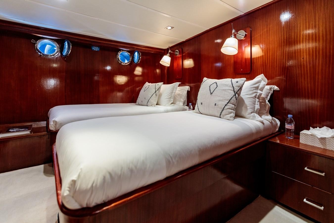 a bed with white sheets aboard VITA DOLCE Yacht for Sale