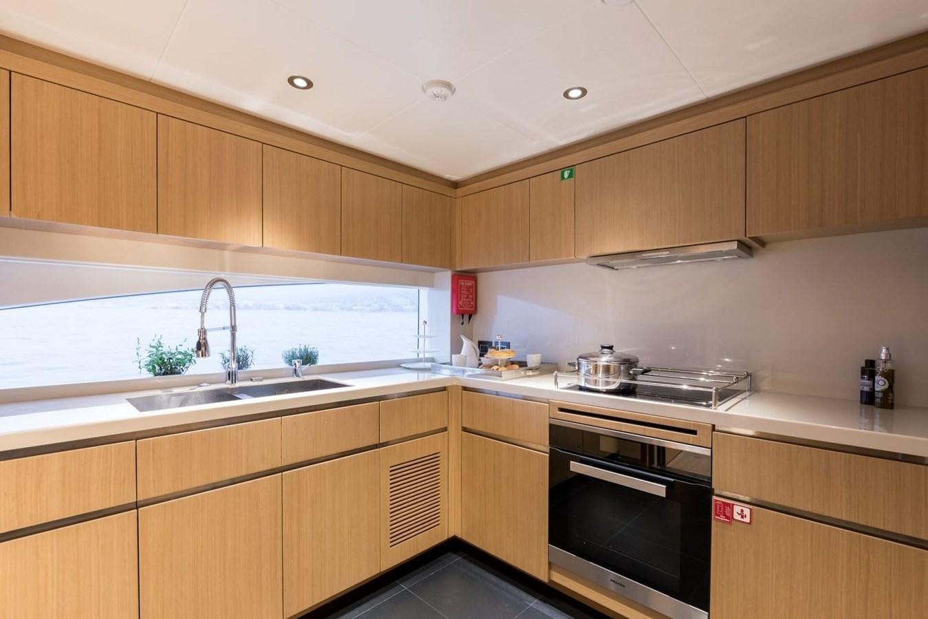 a kitchen with wooden cabinets aboard BARBARA Yacht for Sale