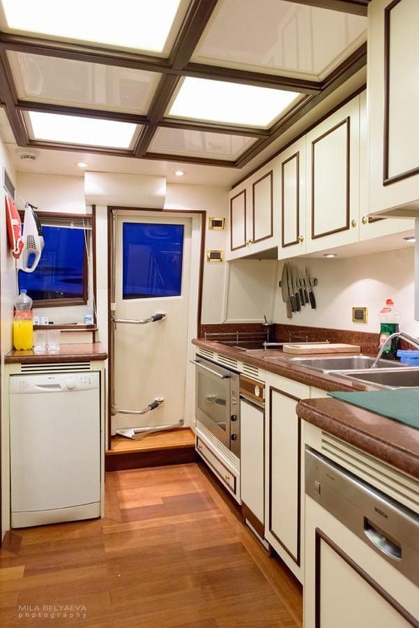 a kitchen with white cabinets aboard GIHRAMAR Yacht for Sale
