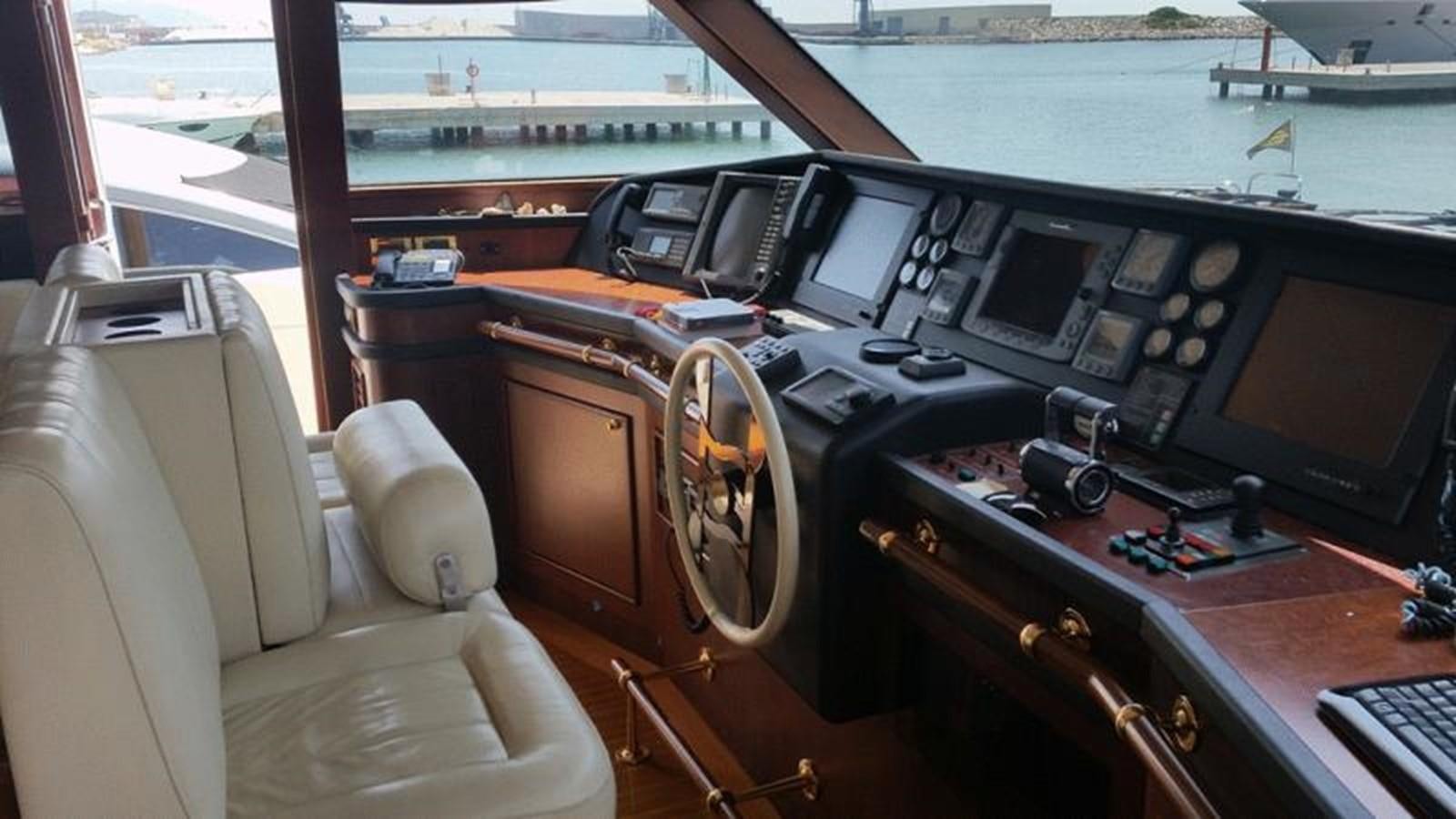 a wooden boat with a desk and computer equipment aboard GIHRAMAR Yacht for Sale