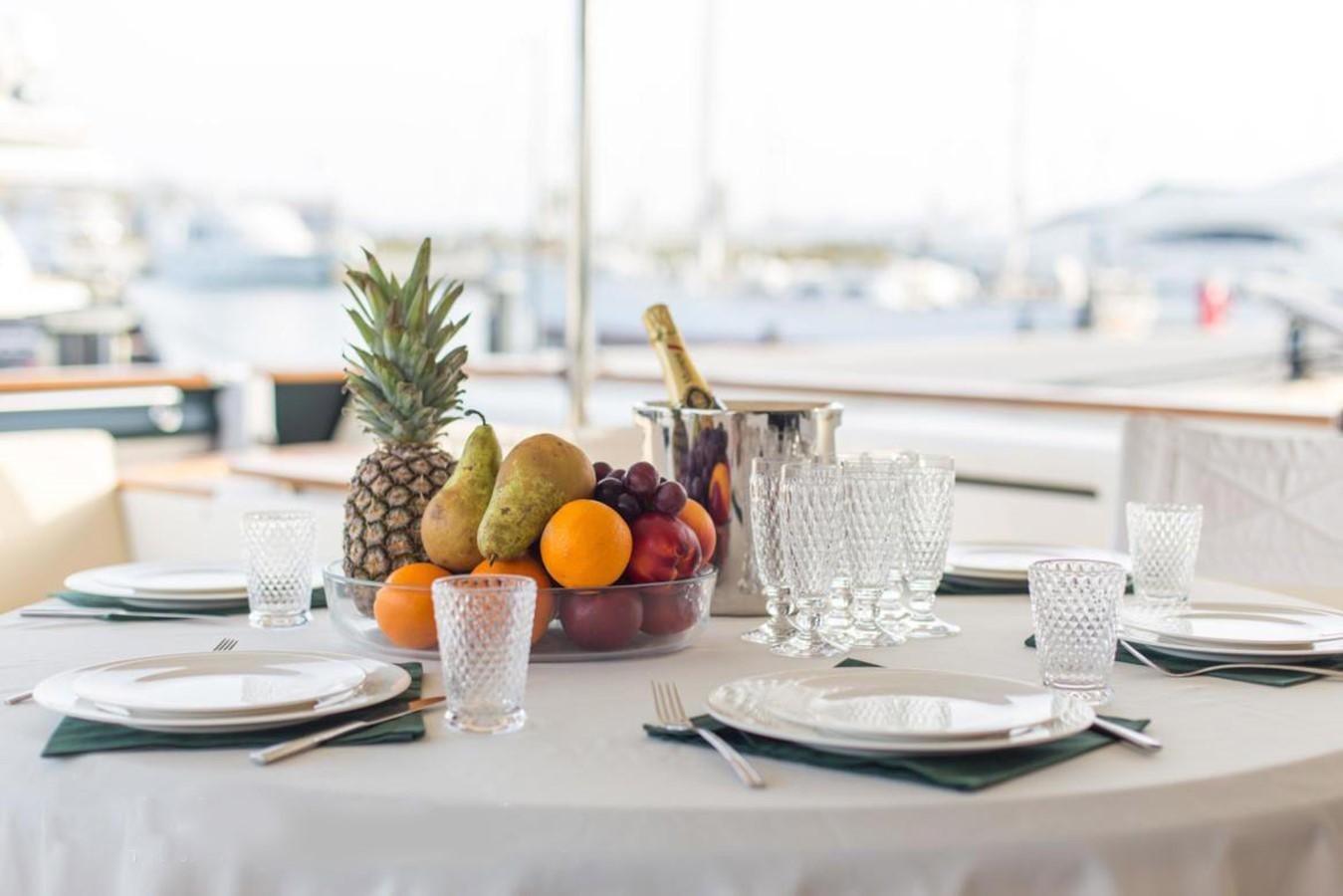 a table with plates and glasses aboard GIHRAMAR Yacht for Sale