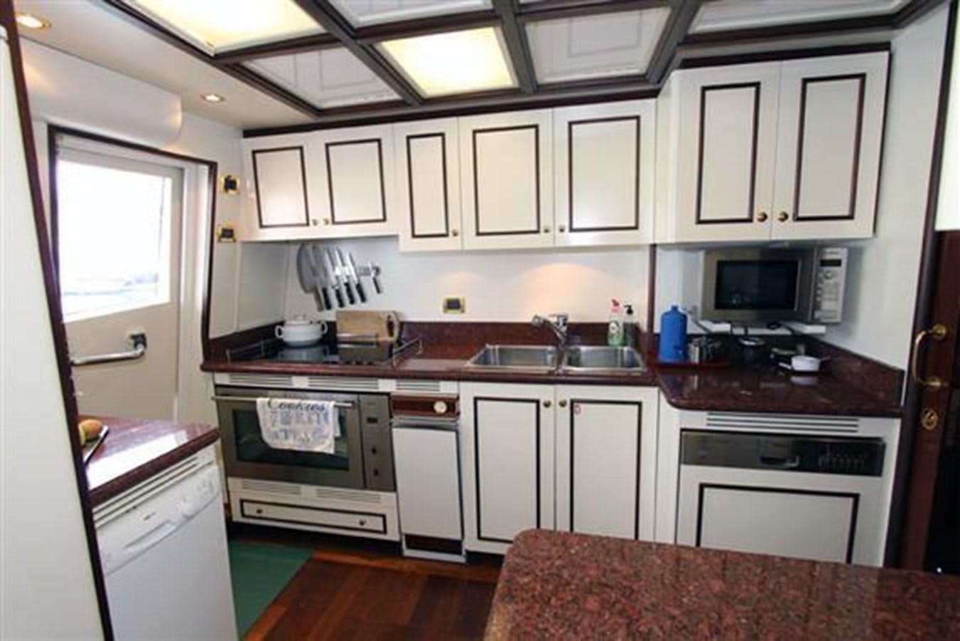 a kitchen with white cabinets aboard GIHRAMAR Yacht for Sale