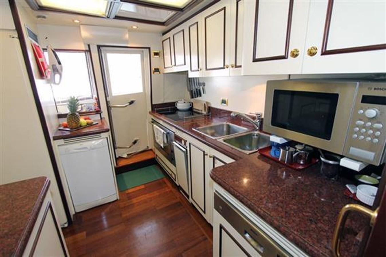 a kitchen with a microwave oven and a sink aboard GIHRAMAR Yacht for Sale