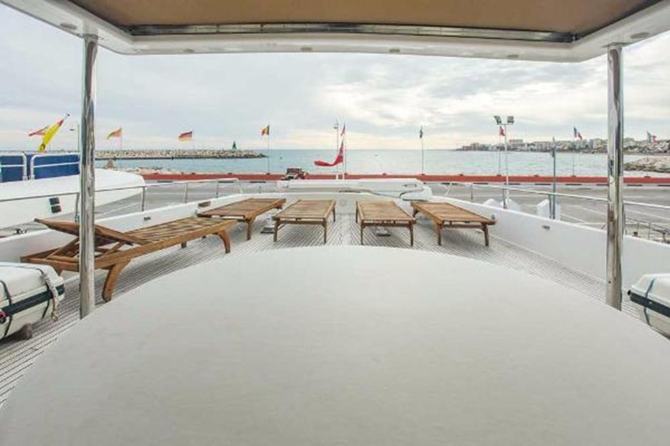 a deck with chairs and tables aboard GIHRAMAR Yacht for Sale