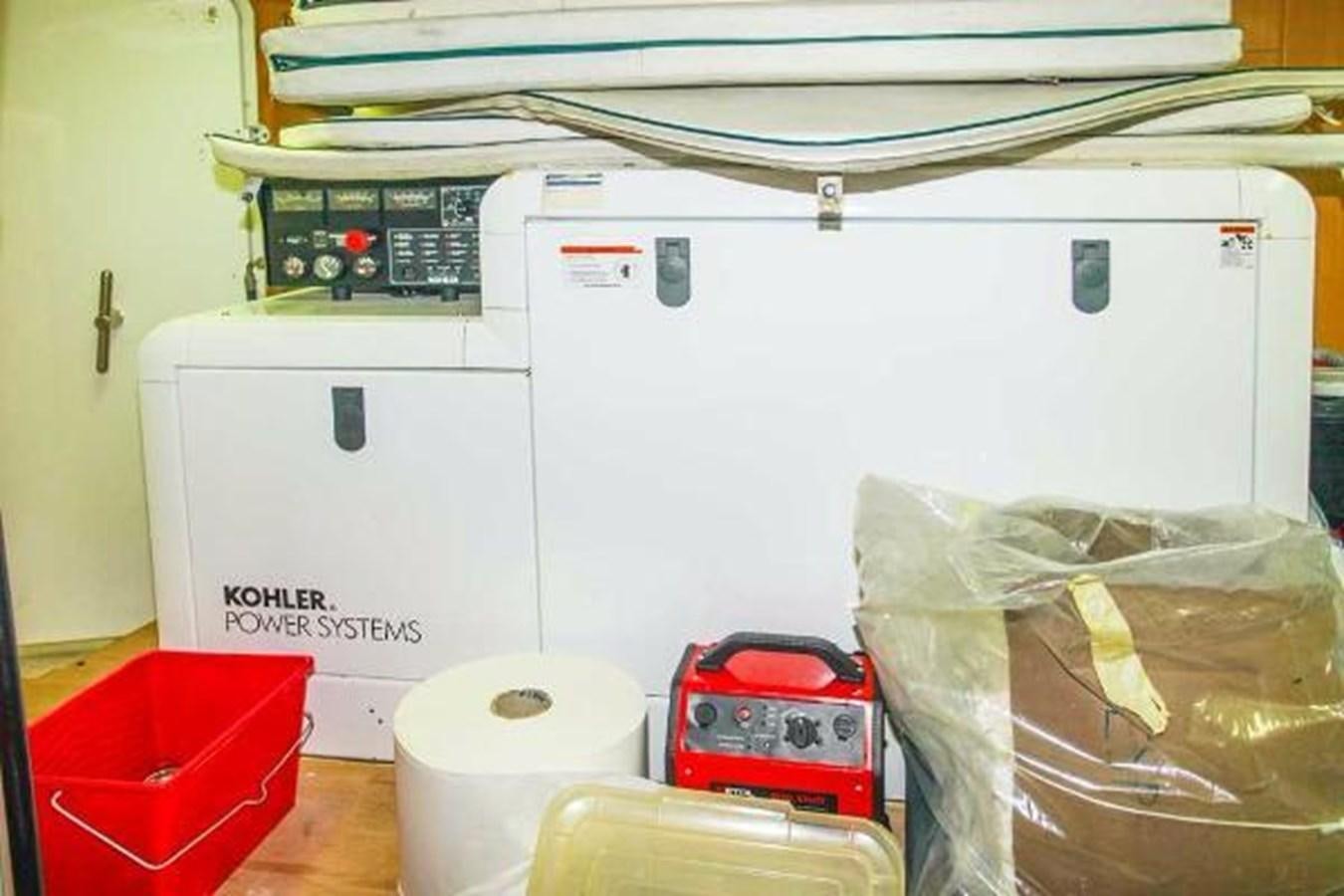 a white machine with a red and black object on top aboard GIHRAMAR Yacht for Sale