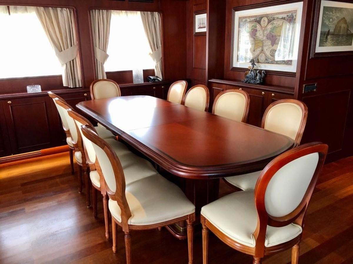 a dining table and chairs aboard GIHRAMAR Yacht for Sale