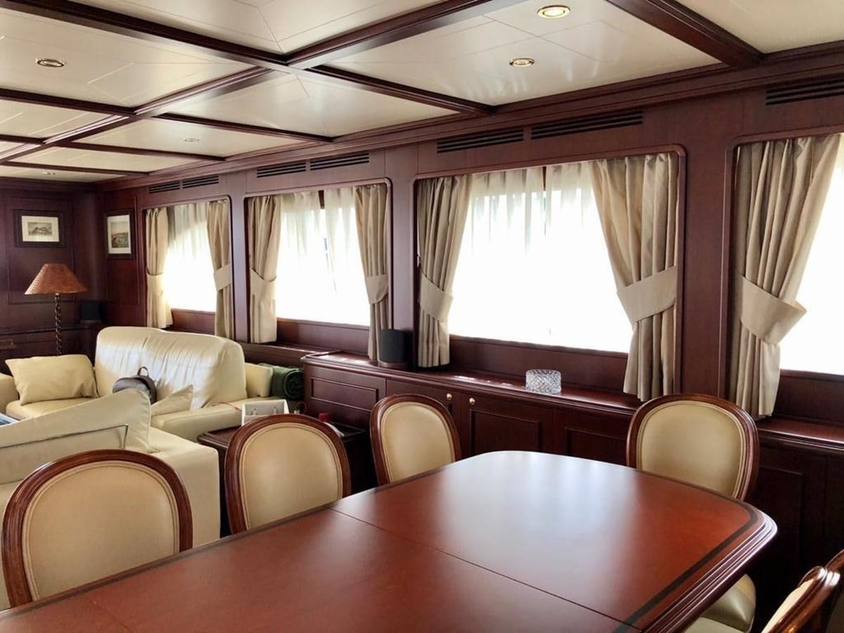 a room with a table and chairs aboard GIHRAMAR Yacht for Sale