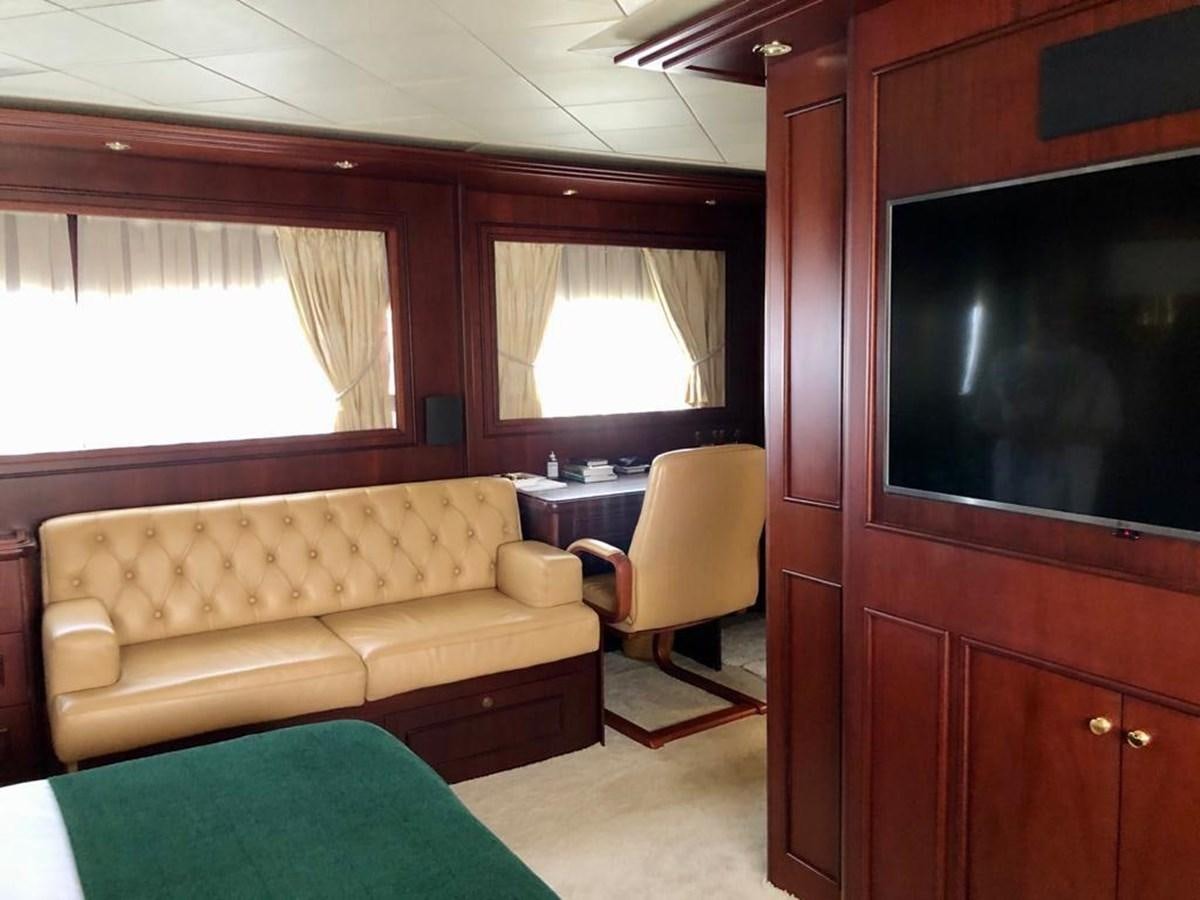 a living room with a couch and a tv aboard GIHRAMAR Yacht for Sale