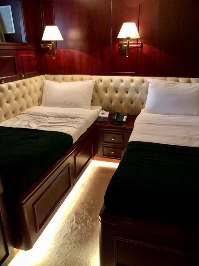 a hotel room with two beds aboard GIHRAMAR Yacht for Sale