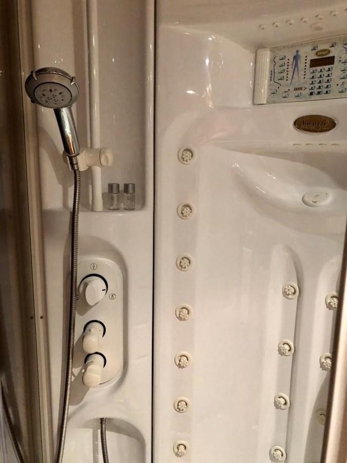a white shower with a clear glass door aboard GIHRAMAR Yacht for Sale