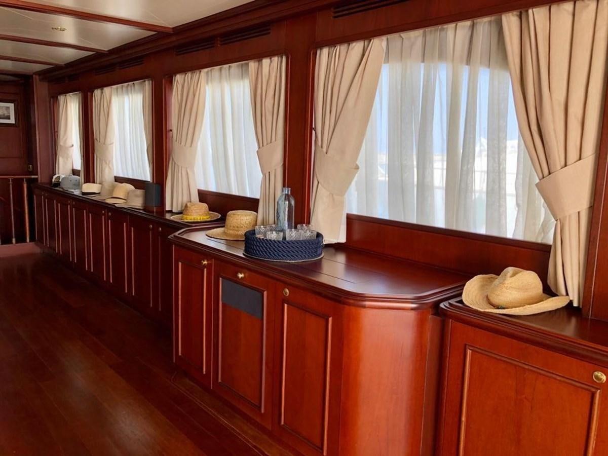 a kitchen with a table and a window aboard GIHRAMAR Yacht for Sale
