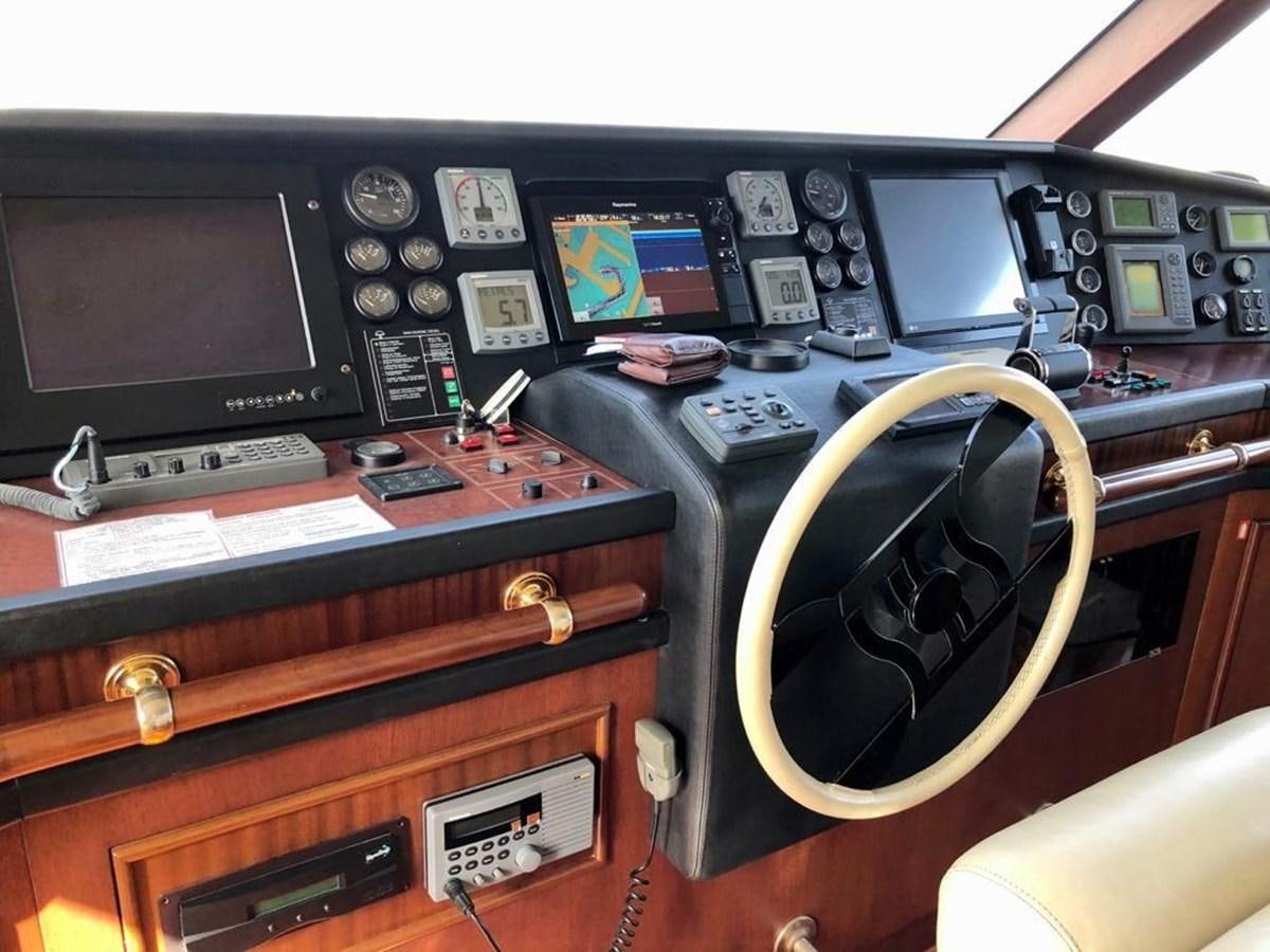 a black and gold desk with a black telephone and a black computer monitor aboard GIHRAMAR Yacht for Sale
