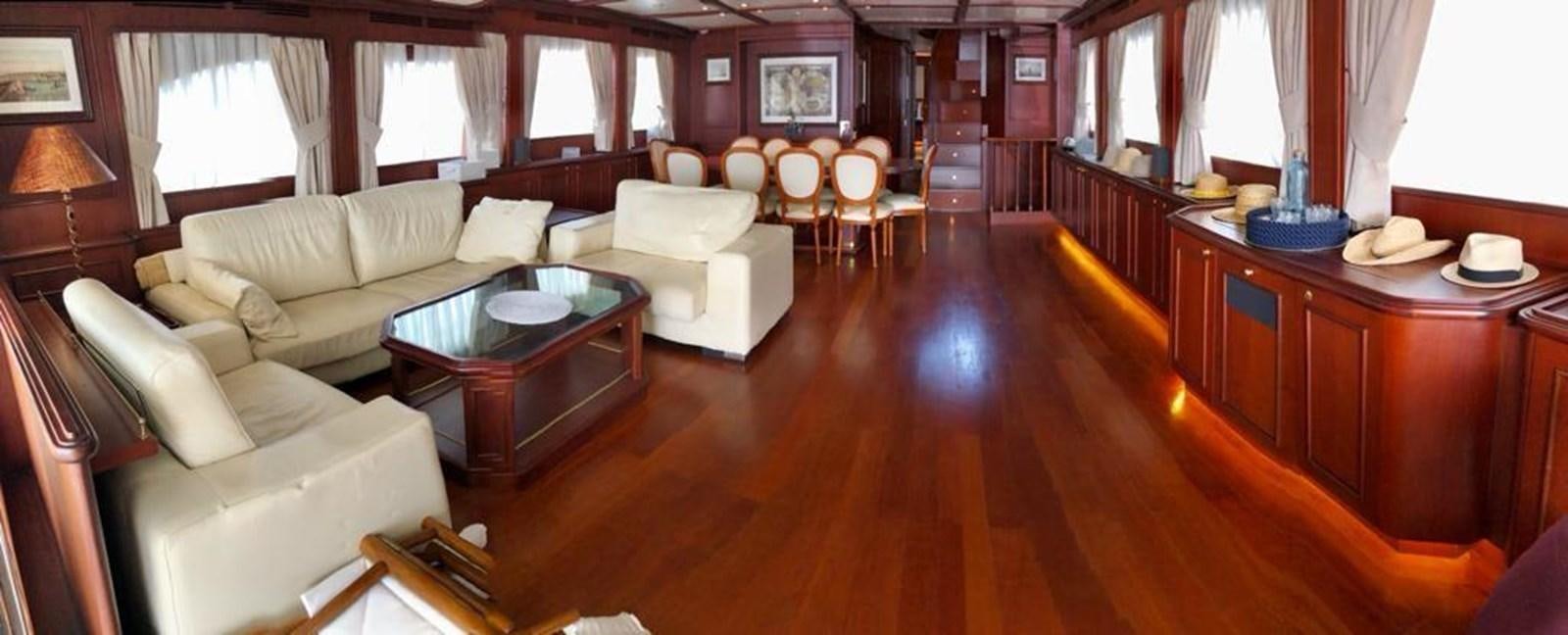 a living room with a table and chairs aboard GIHRAMAR Yacht for Sale