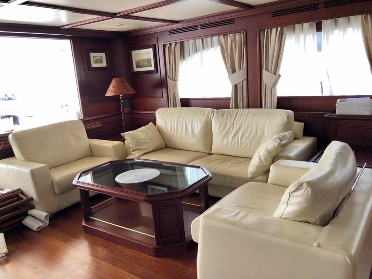 a living room with a couch and a coffee table aboard GIHRAMAR Yacht for Sale