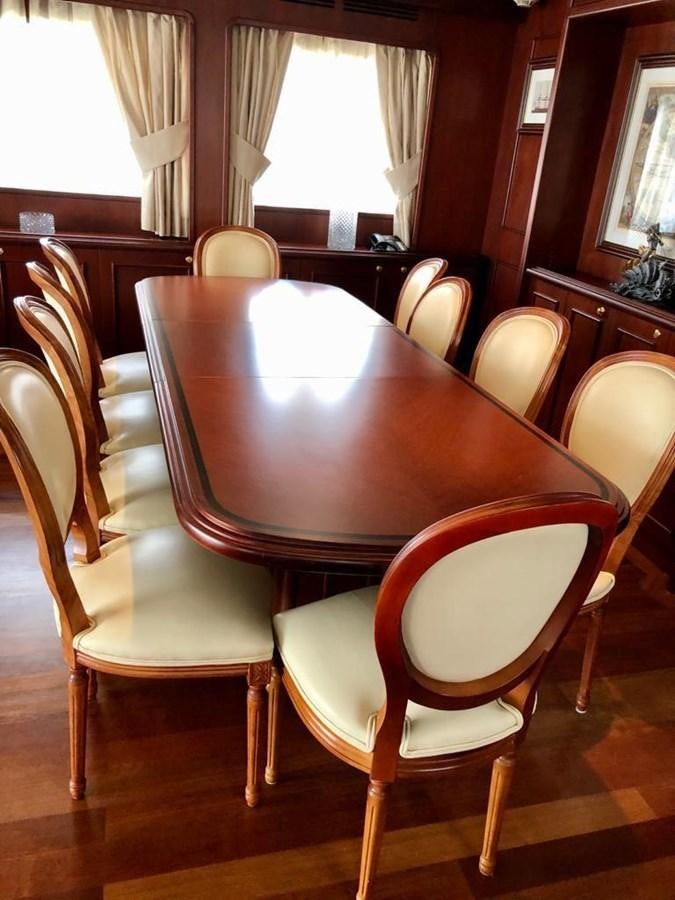 a table with chairs around it aboard GIHRAMAR Yacht for Sale