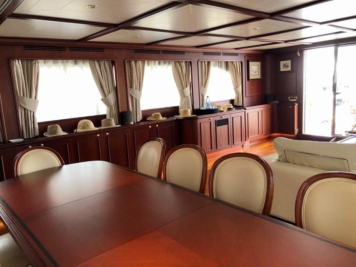 a room with a table and chairs aboard GIHRAMAR Yacht for Sale