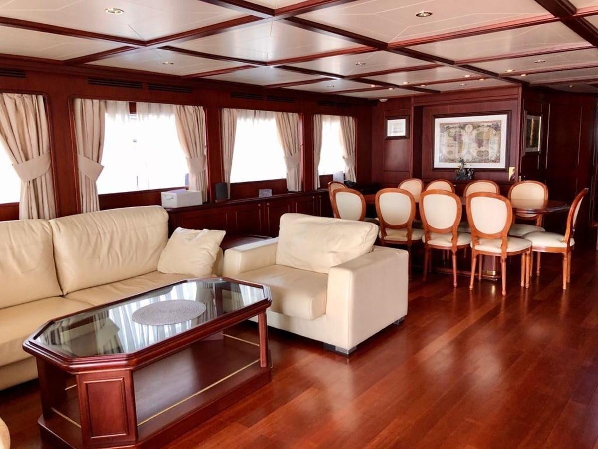 a living room with a table and chairs aboard GIHRAMAR Yacht for Sale