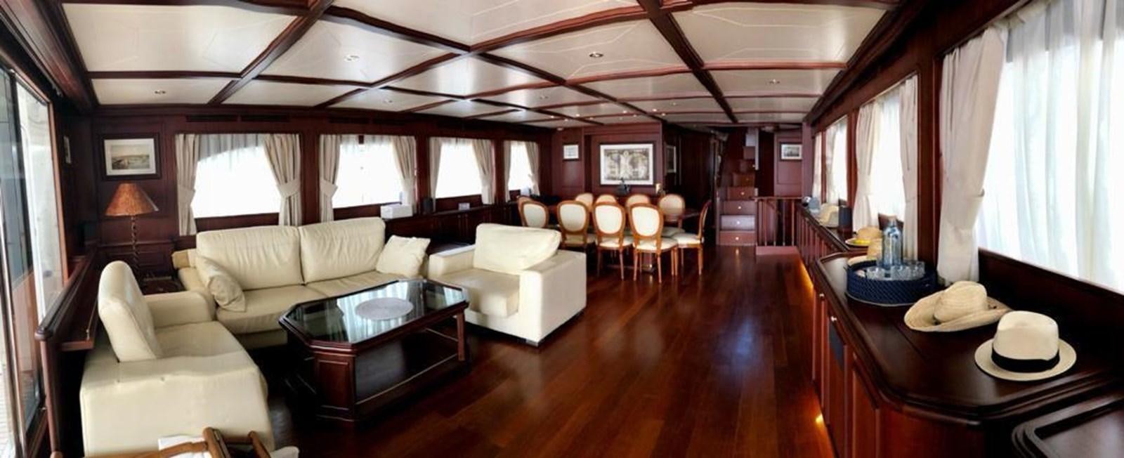 a living room with a large wood floor and a large window aboard GIHRAMAR Yacht for Sale