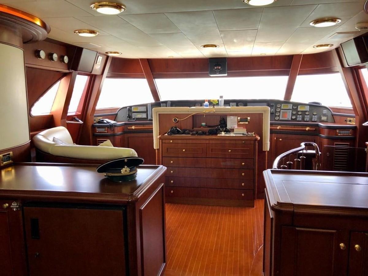 a kitchen with wooden cabinets aboard GIHRAMAR Yacht for Sale
