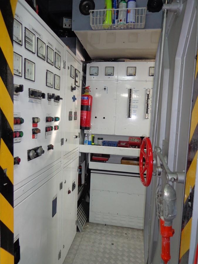 a room with white cabinets and a white wall with black and red buttons aboard AKHIR 31 Yacht for Sale