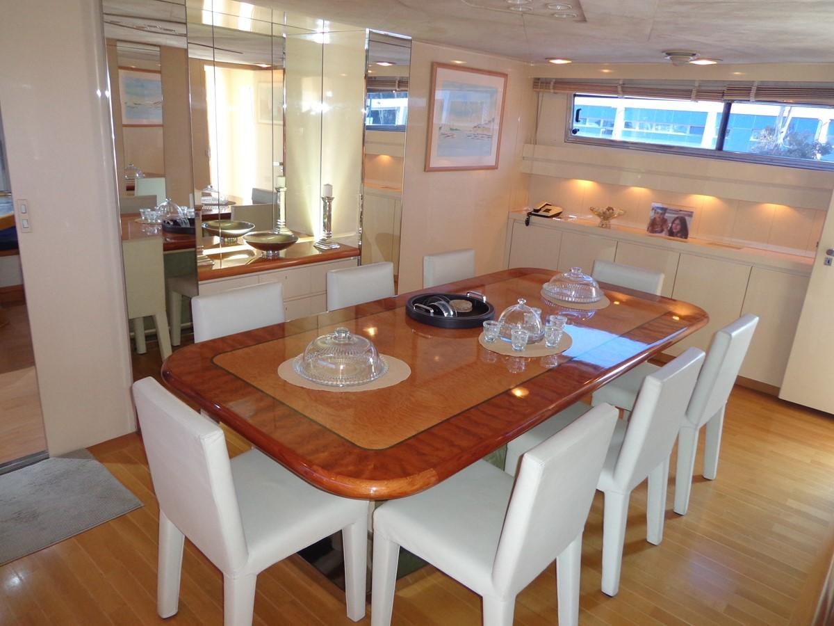 a dining table with chairs aboard AKHIR 31 Yacht for Sale