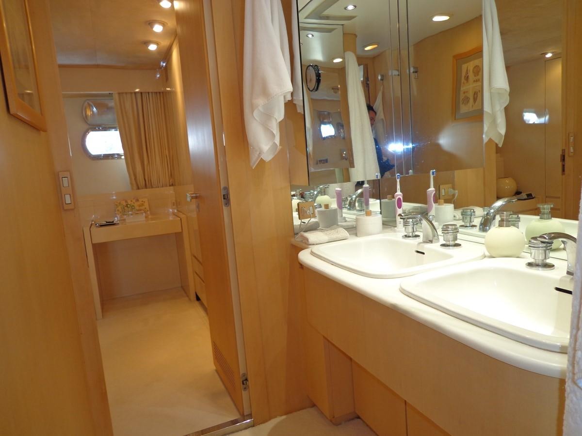 a bathroom with two sinks and a large mirror aboard AKHIR 31 Yacht for Sale