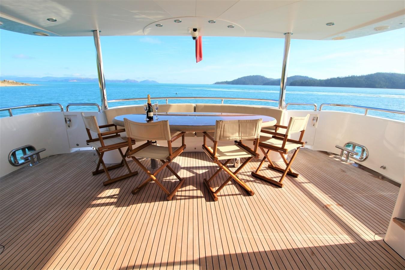 a deck with chairs and a table on it aboard EUPHORIA Yacht for Sale