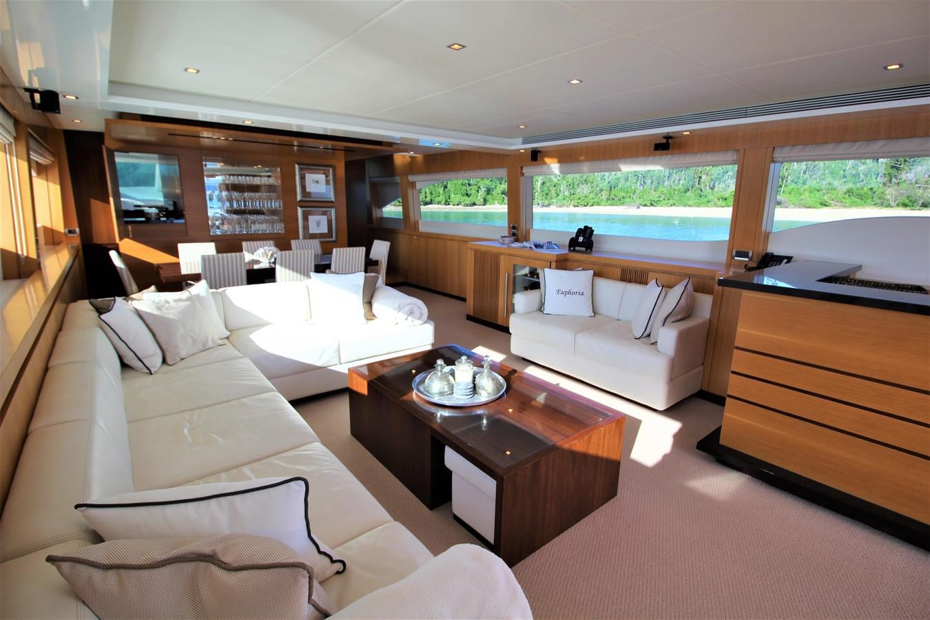 a room with a couch and a coffee table aboard EUPHORIA Yacht for Sale