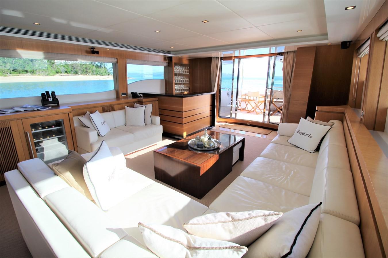 a room with a couch and a coffee table aboard EUPHORIA Yacht for Sale