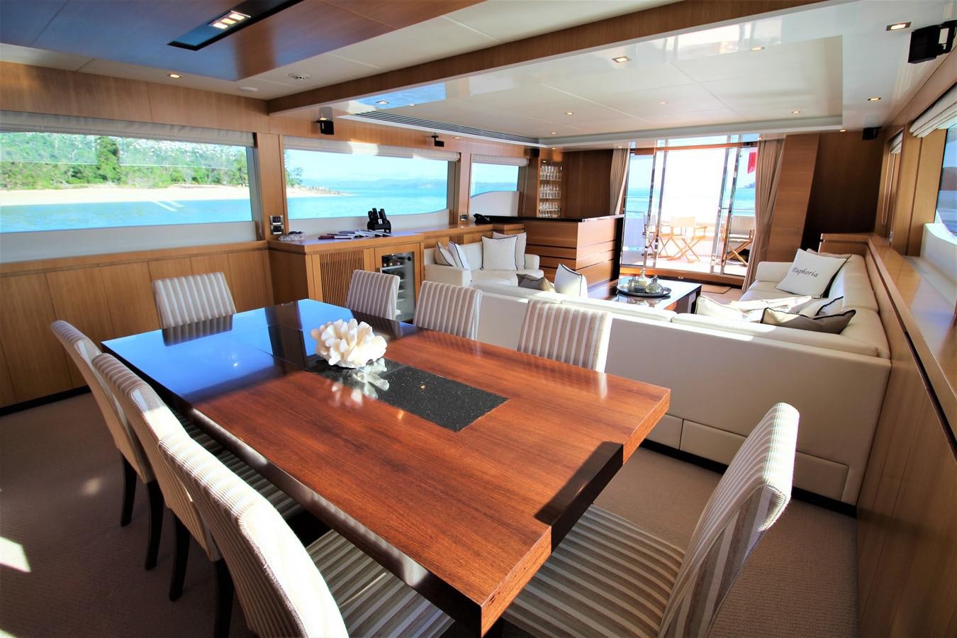 a large room with a table and chairs aboard EUPHORIA Yacht for Sale