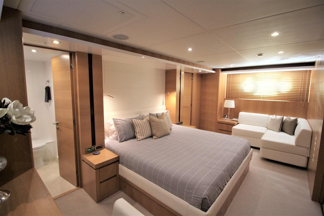 a hotel room with a bed and a couch aboard EUPHORIA Yacht for Sale