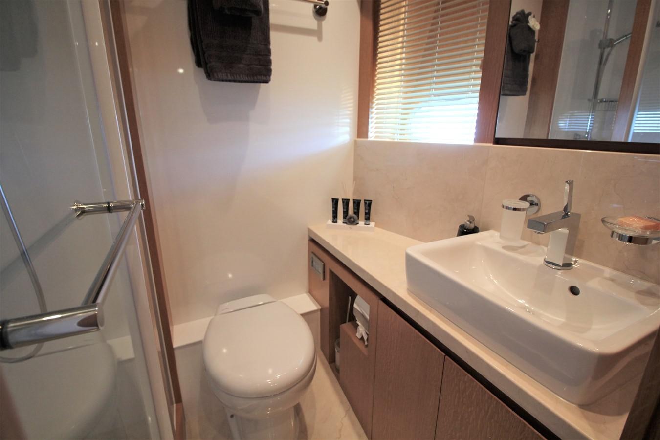 a bathroom with a sink toilet and a shower aboard EUPHORIA Yacht for Sale