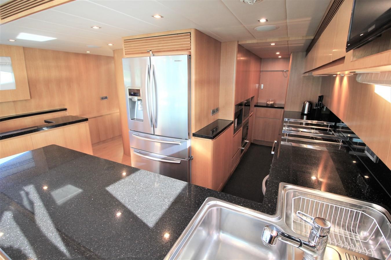 a kitchen with a stainless steel refrigerator aboard EUPHORIA Yacht for Sale